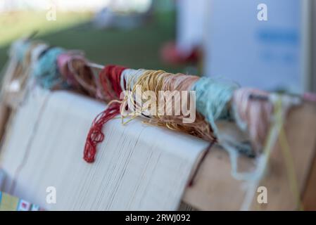 Carpet weaving using traditional techniques on a loom. , close-up of weaving and handmade carpet production. Stock Photo