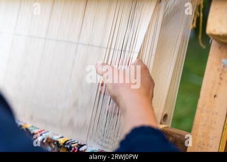 Carpet weaving using traditional techniques on a loom. , close-up of weaving and handmade carpet production. Stock Photo