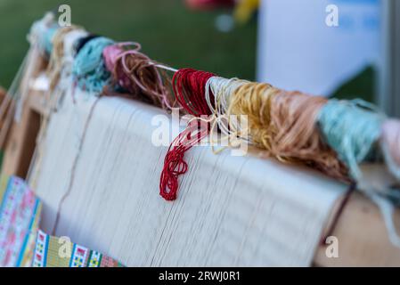 Carpet weaving using traditional techniques on a loom. , close-up of weaving and handmade carpet production. Stock Photo