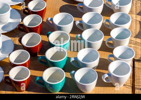 Small empty ceramic coffee cups sold on market outdoors Stock Photo