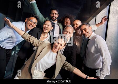 Portrait of excited funny multi-ethnic staff people business team stand in office looking at camera. Stock Photo