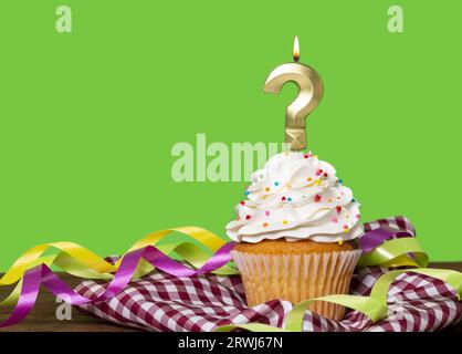 Birthday Cake With Candle Question Mark - On Green Background. Stock Photo