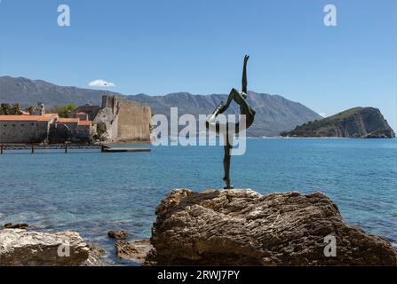 Budvar, Montenegro - April 26th 2022 - Ballerina statue on a rock overlooking the sea in the sunshine Stock Photo