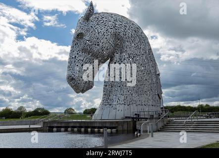 Falkirk, Scotland, UK -  May 10th 2023 - - One of the two Kelpies sculptures sat the junction of the two canals against a blue sky Stock Photo