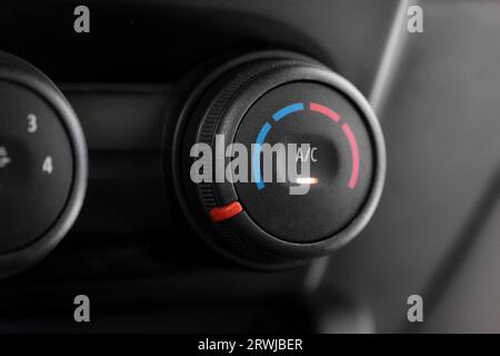 Macro shot of an automobile's air conditioner control dial, emphasizing its texture and design. Stock Photo