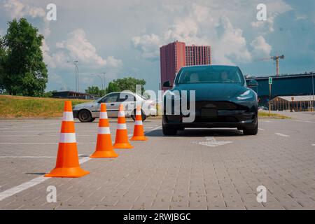 Modern car and safety cones in driving school outdoors Stock Photo - Alamy