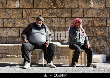 Local men chillin' under the sun outside Saint Theclain Convent in Maaloula, an Aramaic-speaking Christian town built on rugged mountains in Syria Stock Photo