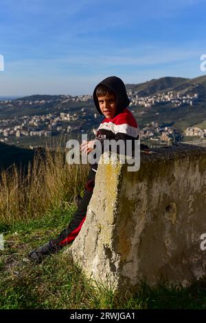 Local shepherd boy posed reluctantly for a photo (I asked him 3 times) in the village right next to Krak des Chevaliers, a medieval crusaders' castle Stock Photo