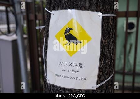 Tokyo, Japan. 19th Sep, 2023. A caution sign warning of crow attacks in Nihombashi. Crows are known in Japan to bully people for their lunch. (Credit Image: © Taidgh Barron/ZUMA Press Wire) EDITORIAL USAGE ONLY! Not for Commercial USAGE! Stock Photo