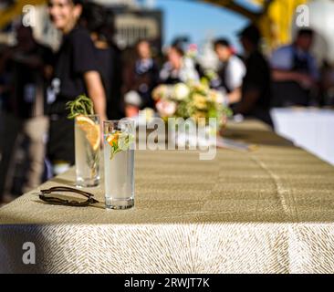 Selective focus of two cocktail glasses and long table at the annual iconic Farm-to-Fork festival Tower Bridge dinner, hosted by Visit Sacramento. Stock Photo