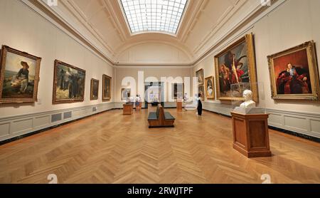 Visitors looking at art works in Boston Fine Art museum Stock Photo