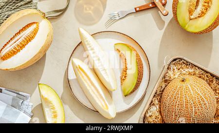 Various sliced melons on a light stone background Stock Photo