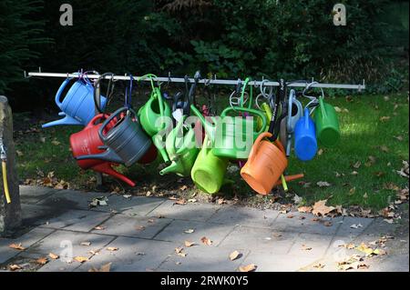 Cologne, Germany. 10th Sep, 2023. Here hang watering cans that can be borrowed for a fee at the Cologne celebrity cemetery Melaten Credit: Horst Galuschka/dpa/Alamy Live News Stock Photo
