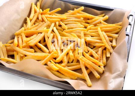 Frozen fries on the baking tray Stock Photo