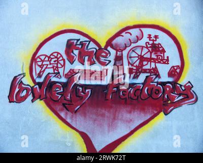 Graffiti on the building of a closed pit, heart shape with drawings of a pit and the text Stock Photo