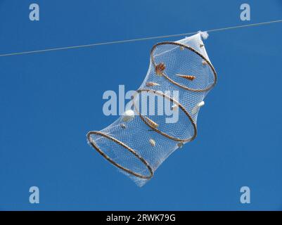 With decorated white cage moved by the wind, background blue sky Stock Photo