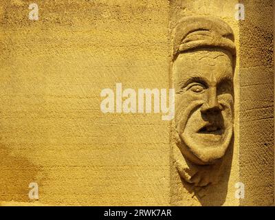 Beautiful stone carving, male portrait, on a house wall of red sandstone in Colmar France Stock Photo