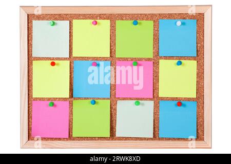 Pieces of blank colorful note papers on a cork bulletin board, isolated on white background Stock Photo