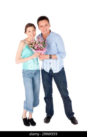 Casual happy loving couple posing together on white isolated background Stock Photo