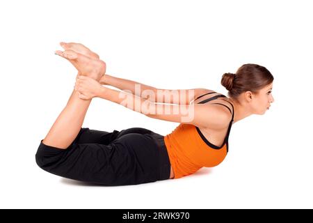 woman practicing yoga exercise called bow pose sanskrit name dhanurasana this pose improves posture rejuvenates the spine enhancing blood 2rwk970
