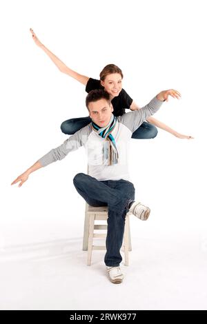 Relaxed funny couple doing aeroplane pose Stock Photo