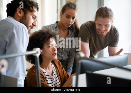Programmers cooperating at IT company developing apps. People business work office concept Stock Photo