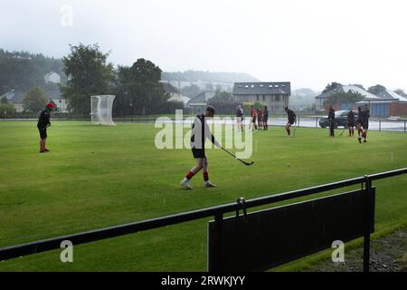 The home team players warming up before Oban Camanachd play Kingussie in a Premiership shinty match at Mossfield Park in Oban. The home side were established in 1889 and have always been one of the leading clubs in the sport played almost exclusively in Scotland. The visitors won this top-division encounter by 2 goals to 1, watched by a crowd of around 100 spectators. Stock Photo