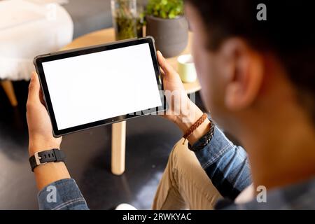 Happy biracial man working at home, and having video call Stock Photo