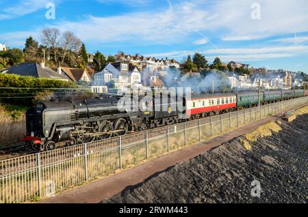 BR Standard Class 7 70000 Britannia steam locomotive hauling a steam special train from Southend, Essex passing Chalkwell beach by Thames Estuary Stock Photo