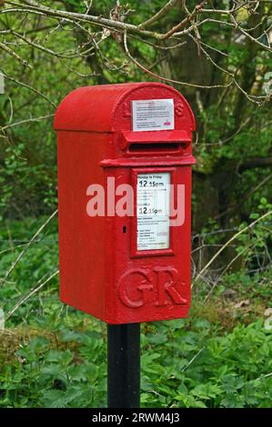 Postbox with GR symbol. Abbey St. Bathans, Berwickshire, Scottish Borders, Scotland, United Kingdom, Europe. Stock Photo