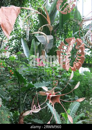 Suspended sculptures by Indian artist Ranjani Shettar in 'Cloud Songs on the Horizon' hanging above the exotic plants in the Barbican Conservatory. Stock Photo