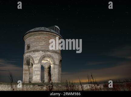 Chesteron Windmill tower before dawn with stars and tower illumination Stock Photo