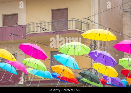 Colorful umbrellas spread out on the street. Mazara del Vallo, town in southwestern of Sicily, Italy, Europe. Stock Photo