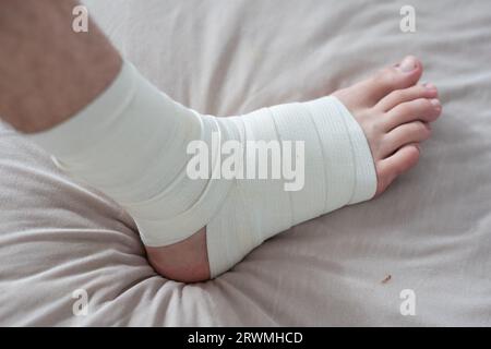 man using put on elastic bandage with legs having leg pain Stock Photo