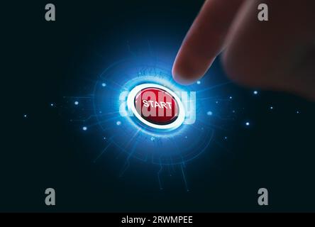 Finger pressing red start button on dark background, Hand push a start switch button with a blue light illuminated on around. Stock Photo