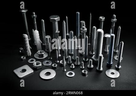 group of various screws, bolts and fasteners on black background Stock Photo
