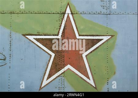 A star on the fuselage of an old military helicopter. The symbol of the Soviet Union is a red star. Stock Photo