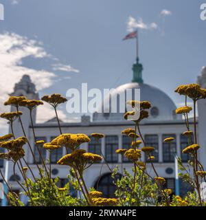 The white dome and towers of Spanish City, Whitley Bay in North Tyneside with flowers and foliage in the foreground Stock Photo