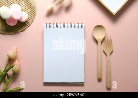 Top view of open spiral blank notebook on pink desk. Stock Photo