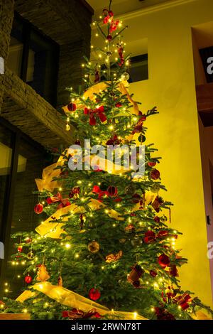 beautifully decorated illuminated christmas tree on crtistmas eve . Stock Photo