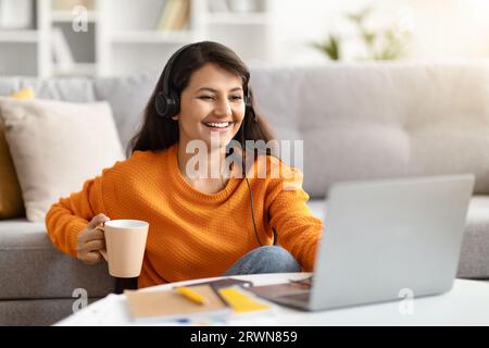 Happy hindu woman remote employee have online meeting with colleagues Stock Photo