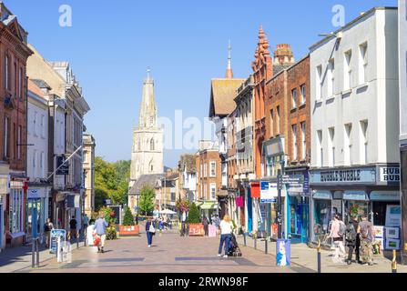 Gloucester city centre pedestrianised Westgate street with shops and people shopping and St Nicholas church spire Gloucestershire England UK GB Europe Stock Photo