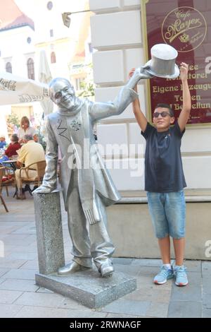 Bratislava, Slovakia - September 01, 2019: Schone Naci statue and boy in old town Main Square Stock Photo