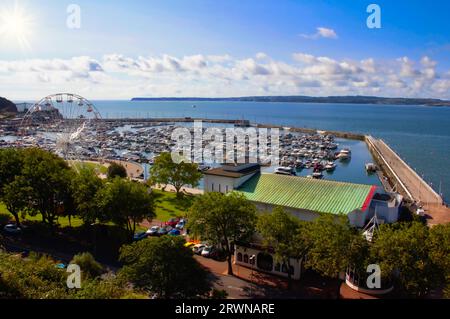 The view over Torquay Marina, Priness theatre and big wheel from Rock Walk, with the headland of Berry Head, Brixham across the bay, Torbay, Devon Stock Photo