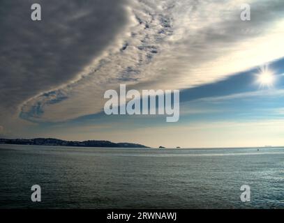 Dramatic cloud formation,Blue sky with sunshine to the East of Torbay, South Devon,Southwest England with Nimbostratus rain clouds Stock Photo