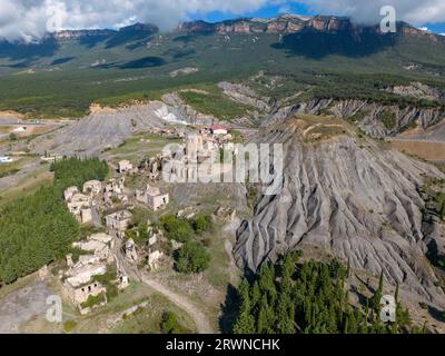 Aerial drone photo of the abandoned ghost town named Esco. Esco is located next to lake Aragon in Northern Spain. Stock Photo