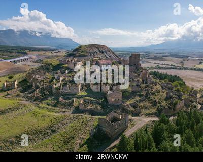 Aerial drone photo of the abandoned ghost town named Esco. Esco is located next to lake Aragon in Northern Spain. Stock Photo