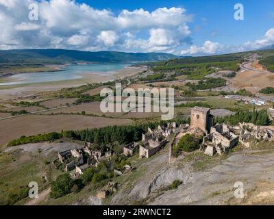 Aerial drone photo of the abandoned ghost town named Esco. Esco is located next to lake Aragon in Northern Spain. Stock Photo