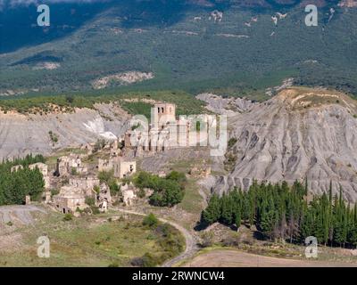 Aerial drone photo of the abandoned ghost town named Esco. Esco is located next to lake Aragon in Northern Spain. Stock Photo