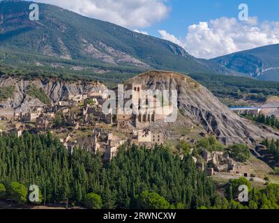 Aerial drone photo of the abandoned ghost town named Esco. Esco is located next to lake Aragon in Northern Spain. Stock Photo